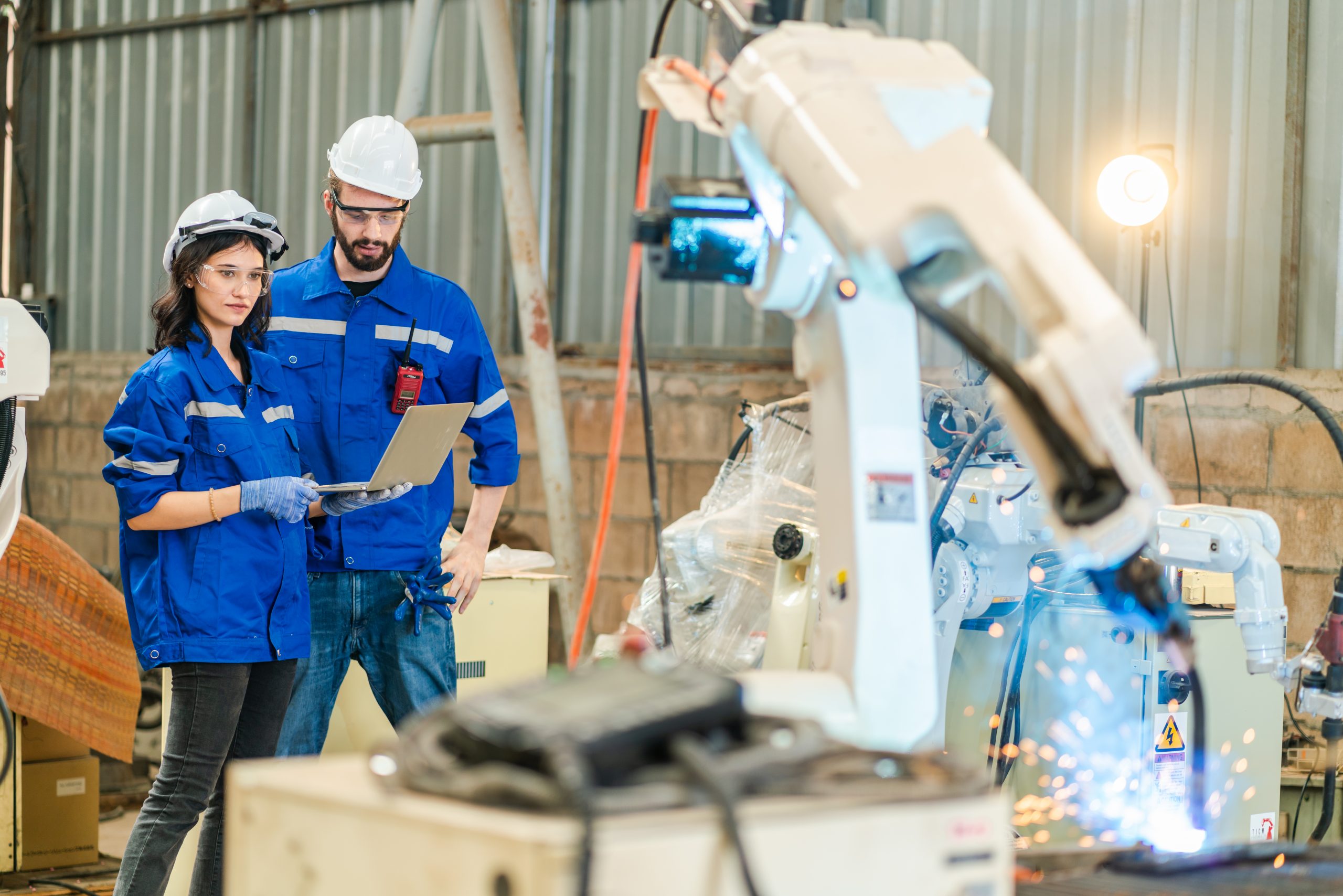 Testing new automation innovation tool for smart industrial, Professional robotic engineers specialist maintenance and control robot arm in factory warehouse, technician teamwork working together