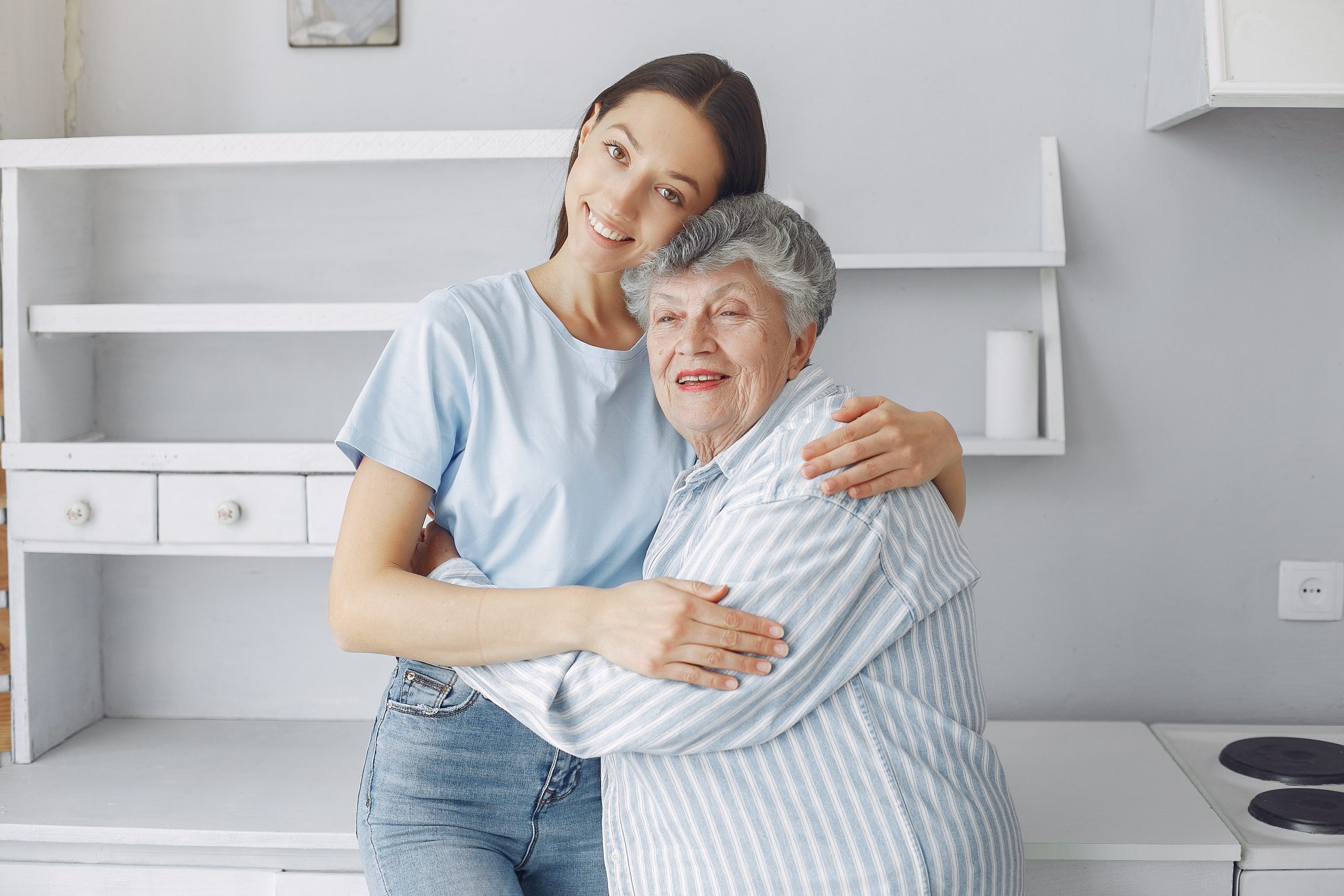 Old woman in a kitchen. Grandparents at home. Woman in a whire shirt