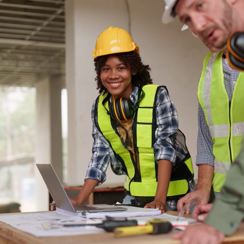 American African Foreman builder woman at construction site. Foreman construction and Engineer working at construction site.