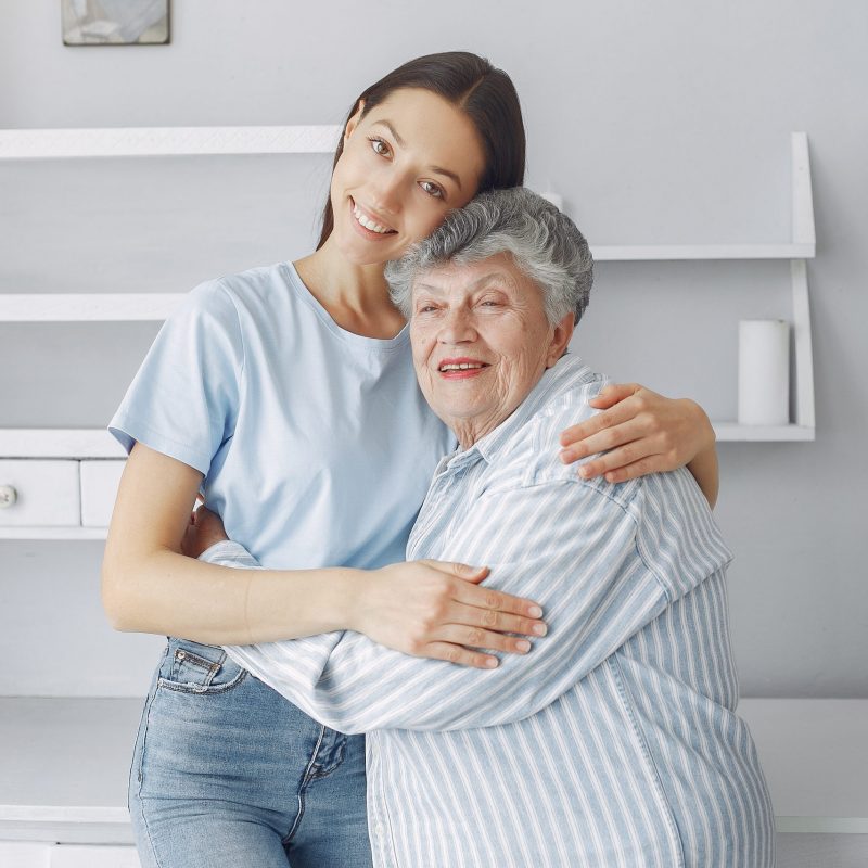 Old woman in a kitchen. Grandparents at home. Woman in a whire shirt