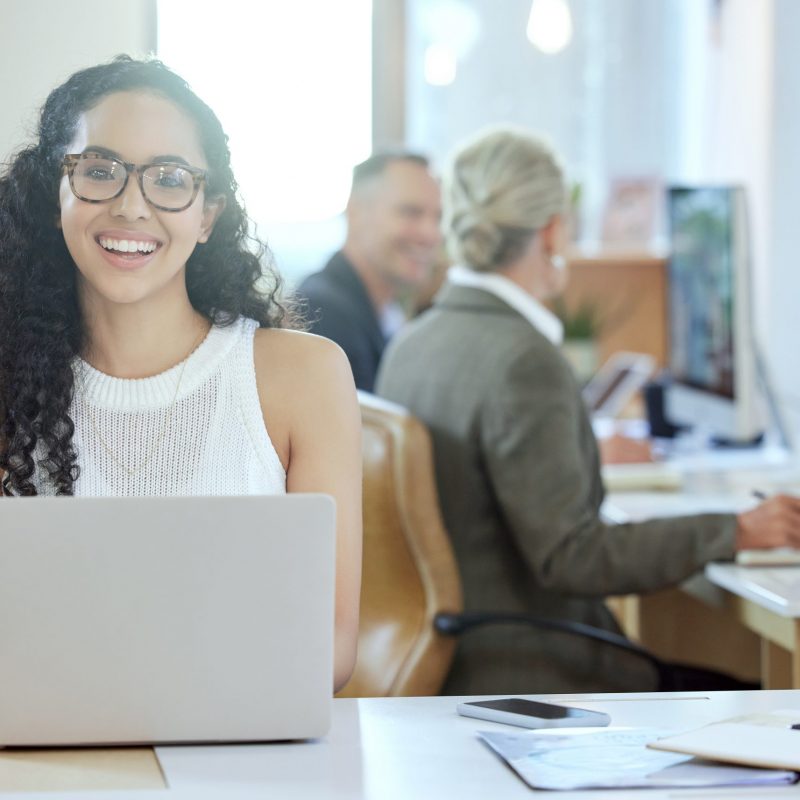 Shot of a young businesswoman using a laptop in an office at work.